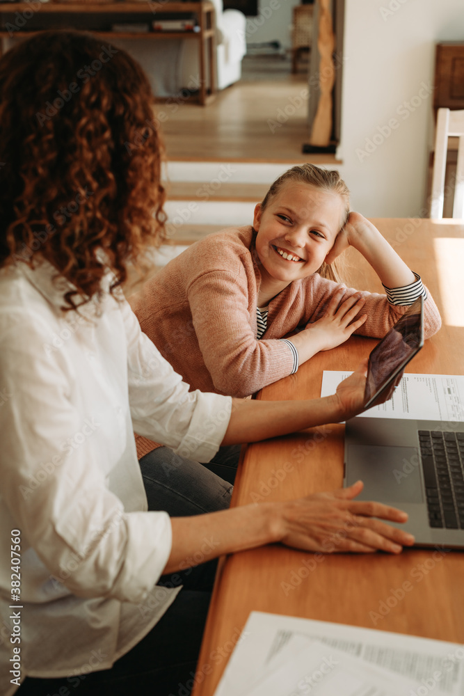 Woman talking with her daughter while working at home