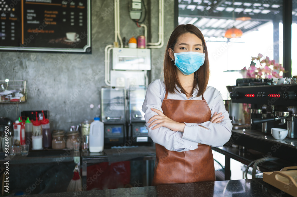 New normal startup small business Portrait of Asian woman barista wearing face mask working in coffe