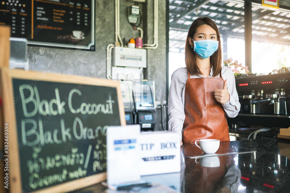 New normal startup small business Portrait of Asian woman barista wearing face mask working in coffe