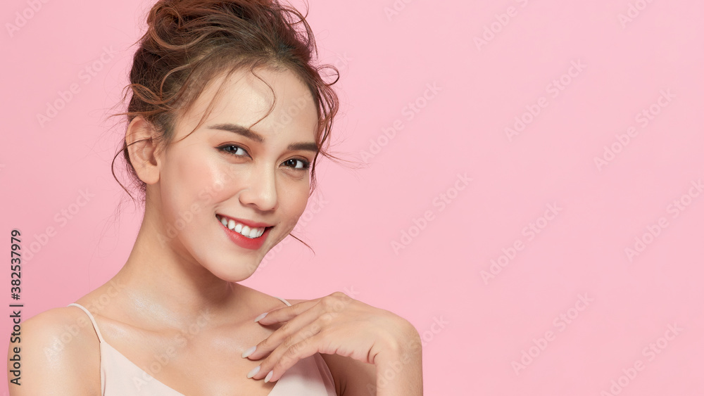 Young female model posing happy gesture, isolated on pink background