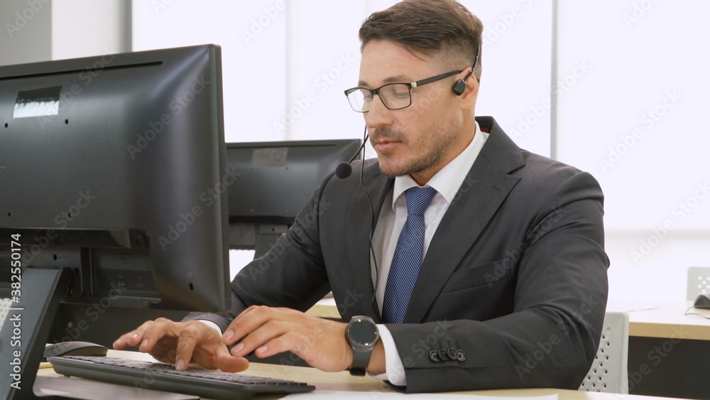 Business people wearing headset working in office to support remote customer or colleague. Call cent