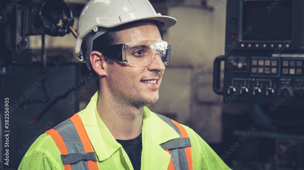 Young factory worker or engineer close up portrait in factory . Industry and engineering concept .