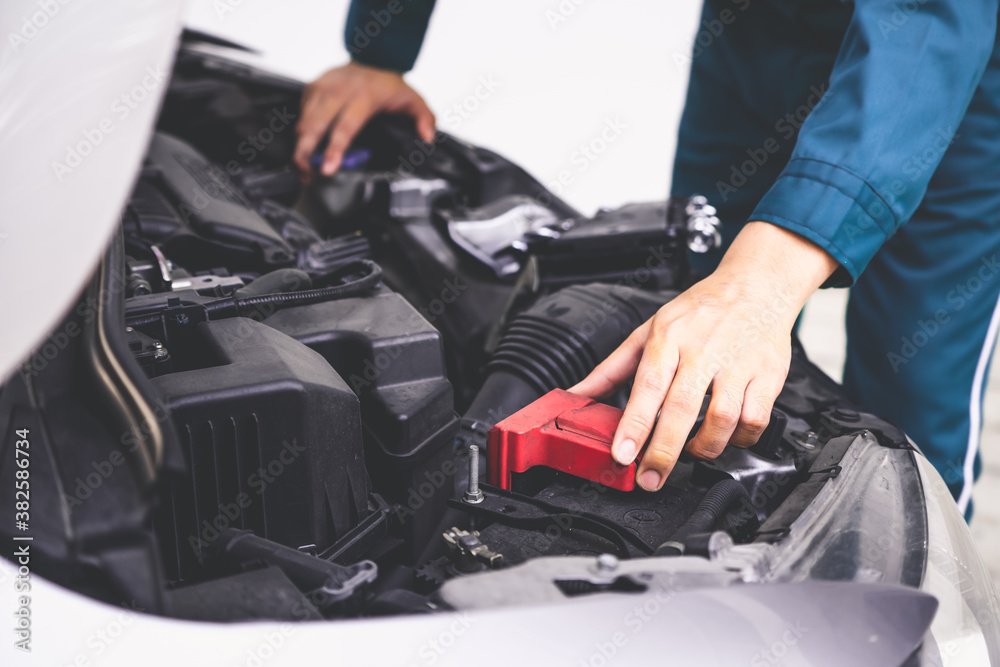 Professional mechanic hand providing car repair and maintenance service in auto garage. Car service 