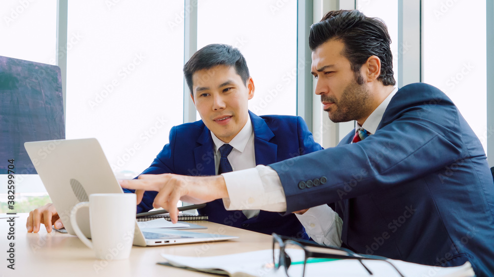 Two business people talk project strategy at office meeting room. Businessman discuss project planni