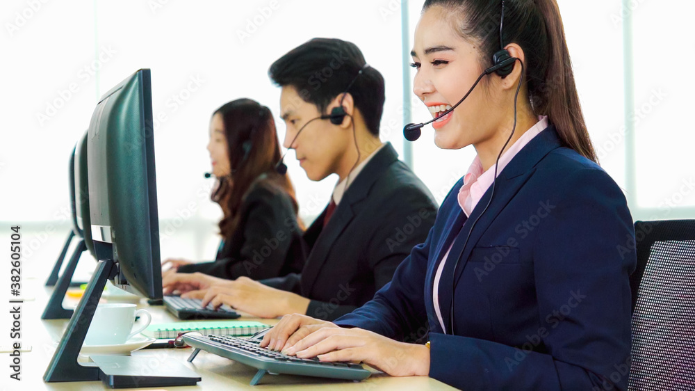 Business people wearing headset working in office to support remote customer or colleague. Call cent