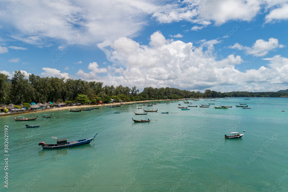 Aerial View Drone shot of Thai traditional longtail fishing boats in the tropical sea beautiful beac