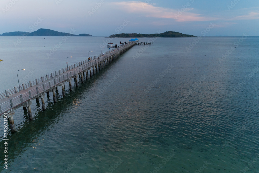 Aerial High angle view drone shot of long bridge in to the tropical sea.