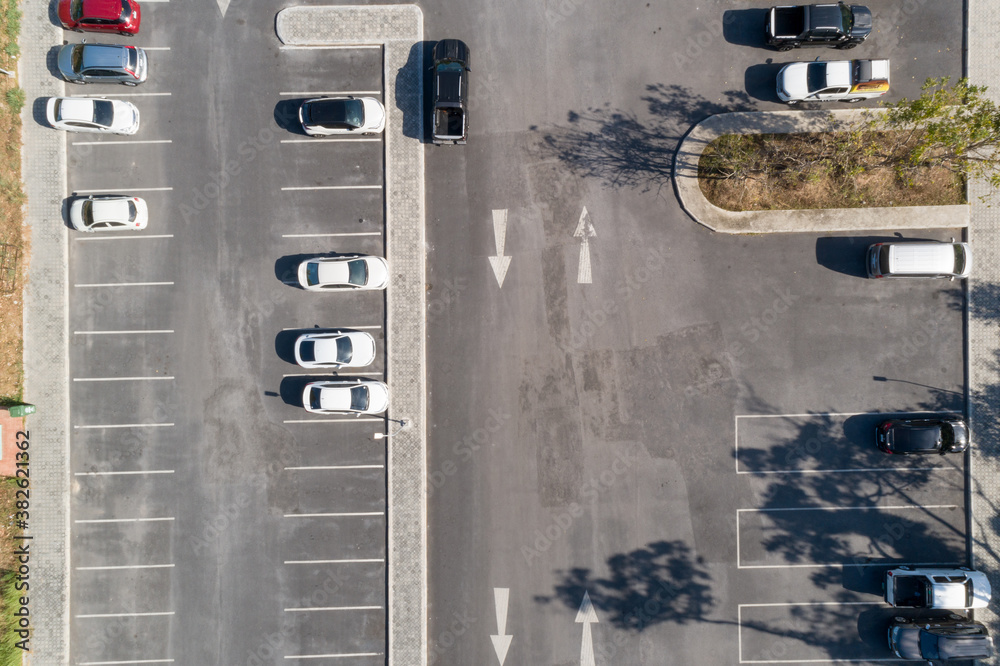 Aerial view drone shot of parking lot outdoors vehicles in the park.