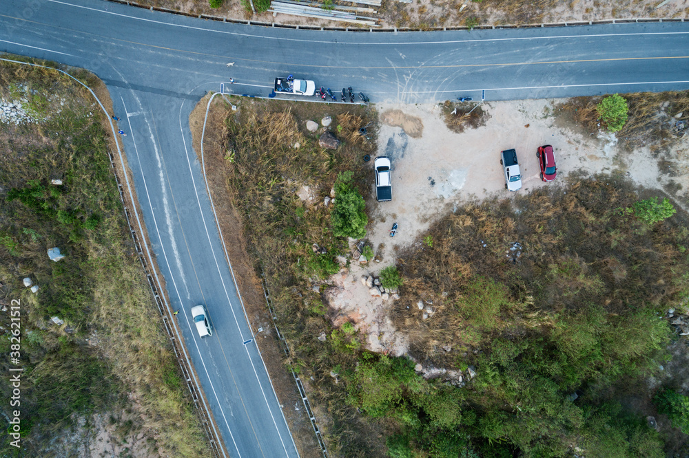 Aerial view top down photo from flying drone of asphalt road with cars and bicycle lane curve road a