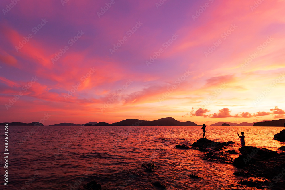 Landscape Long exposure of majestic clouds in the sky sunset or sunrise over sea with reflection in 