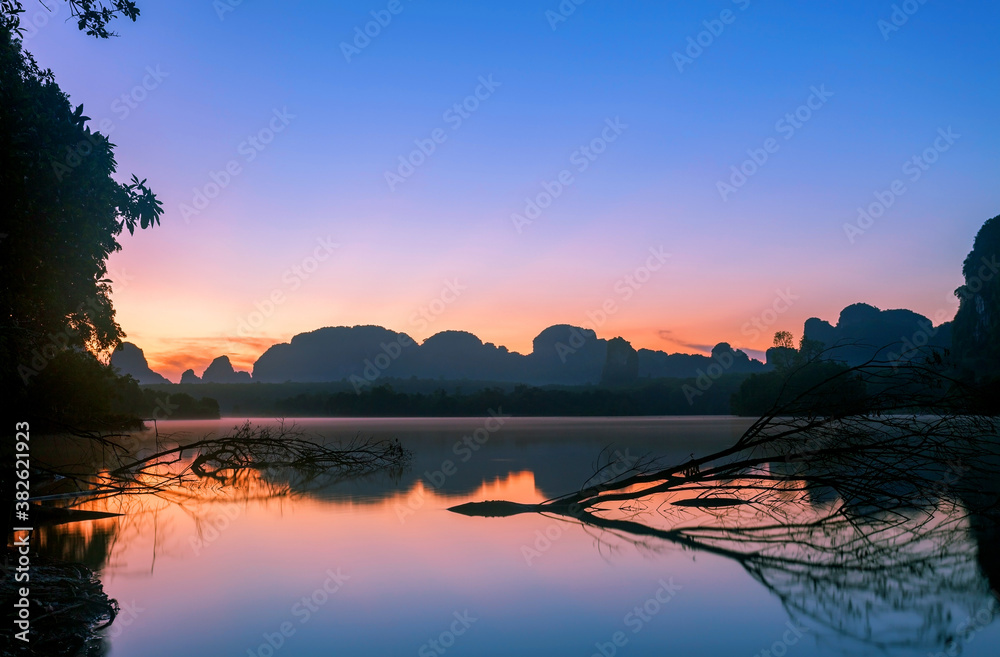 Beautiful landscape light of nature view in morning with reflections in the water during sunrise or 