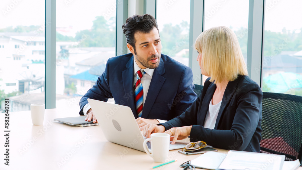 Two business people talk project strategy at office meeting room. Businessman discuss project planni