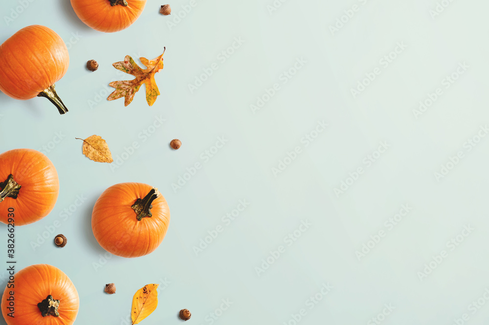 Autumn pumpkins with leaves - overhead view flat lay