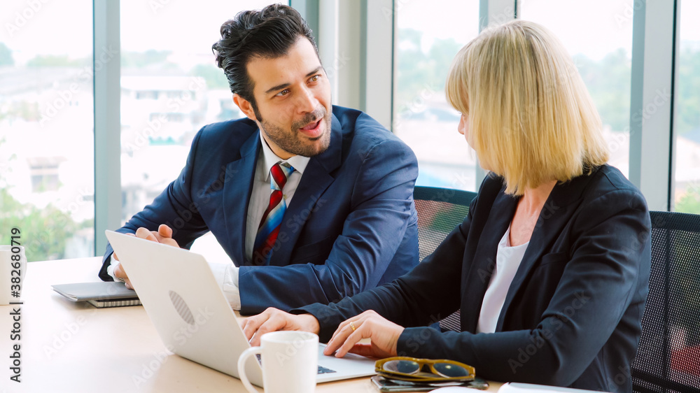 Two business people talk project strategy at office meeting room. Businessman discuss project planni