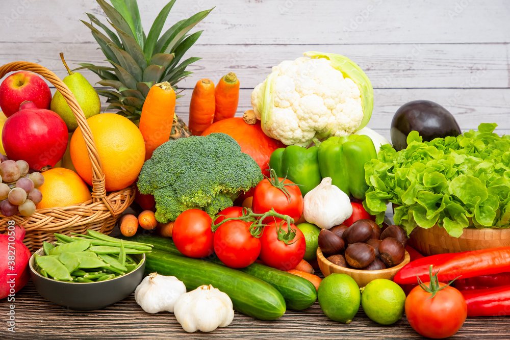 Group vegetables and Fruits Apples, grapes, oranges, pineapples, bananas in a wooden basket with car