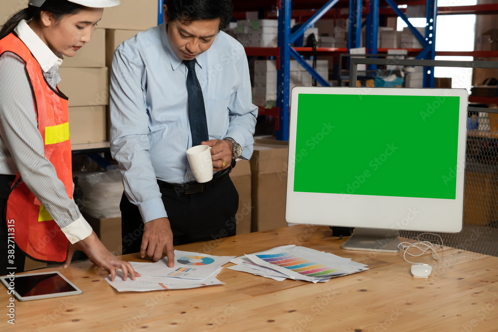 Computer with green screen display in warehouse storage room . Delivery and transportation software 