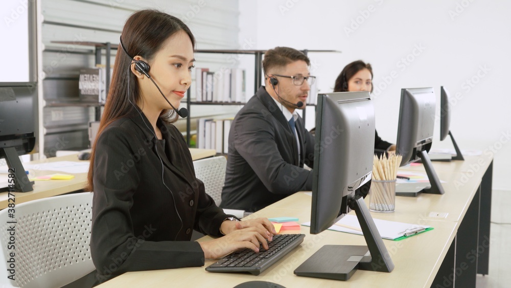 Business people wearing headset working in office to support remote customer or colleague. Call cent