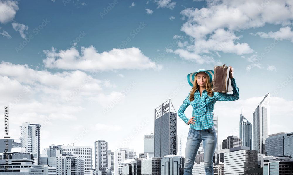 Attractive girl with old suitcase