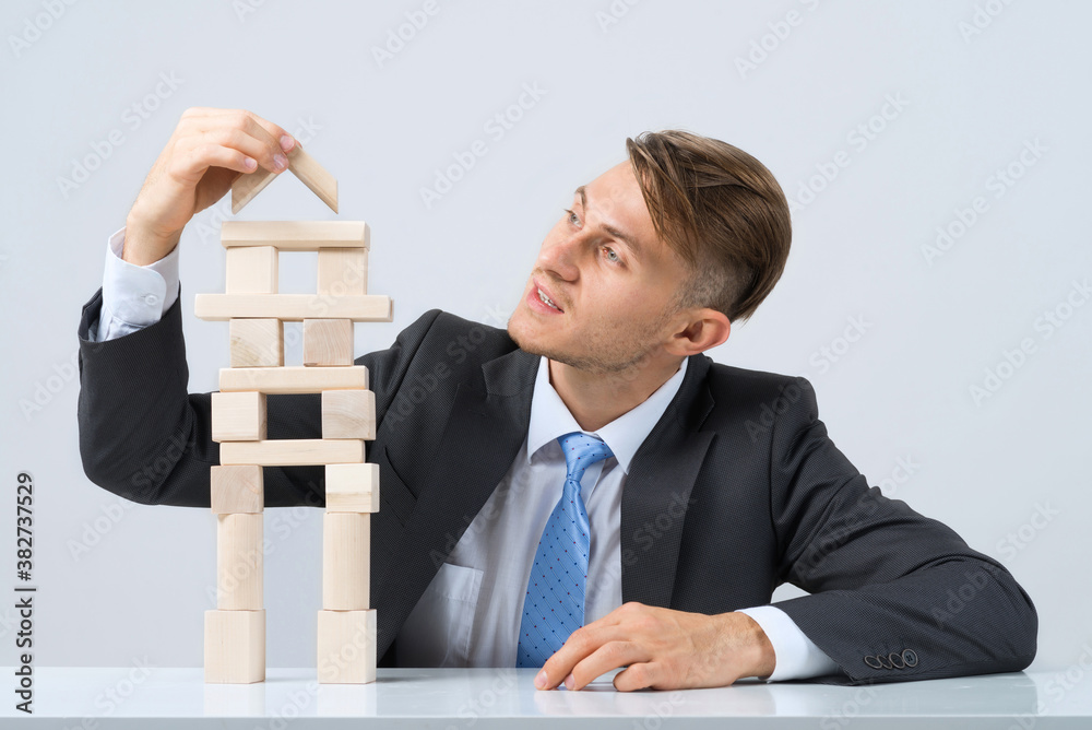 Businessman making tower