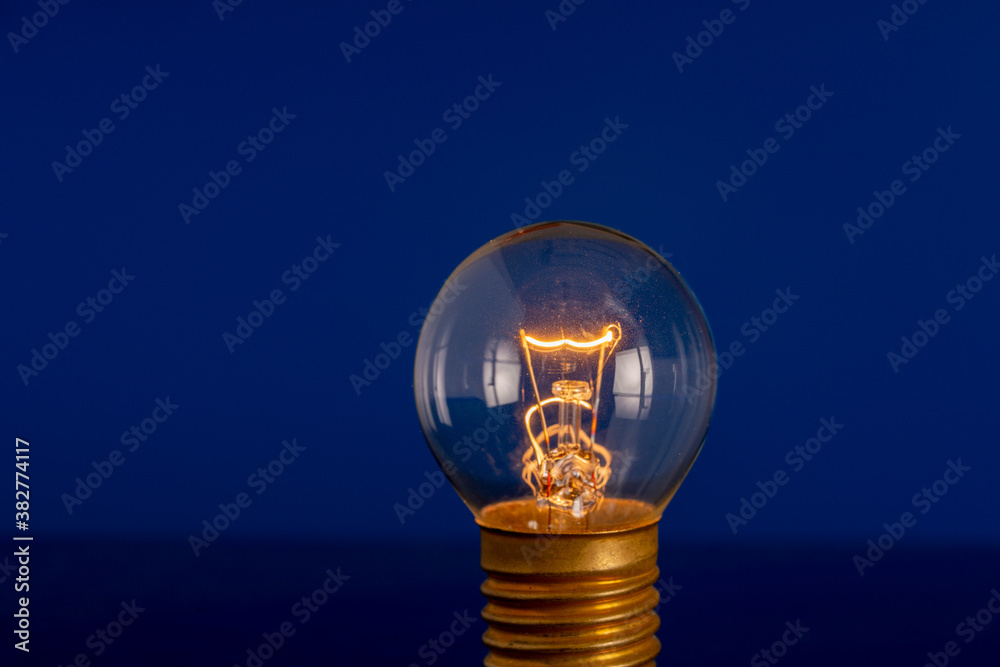 Vintage hanging light bulb over blue background