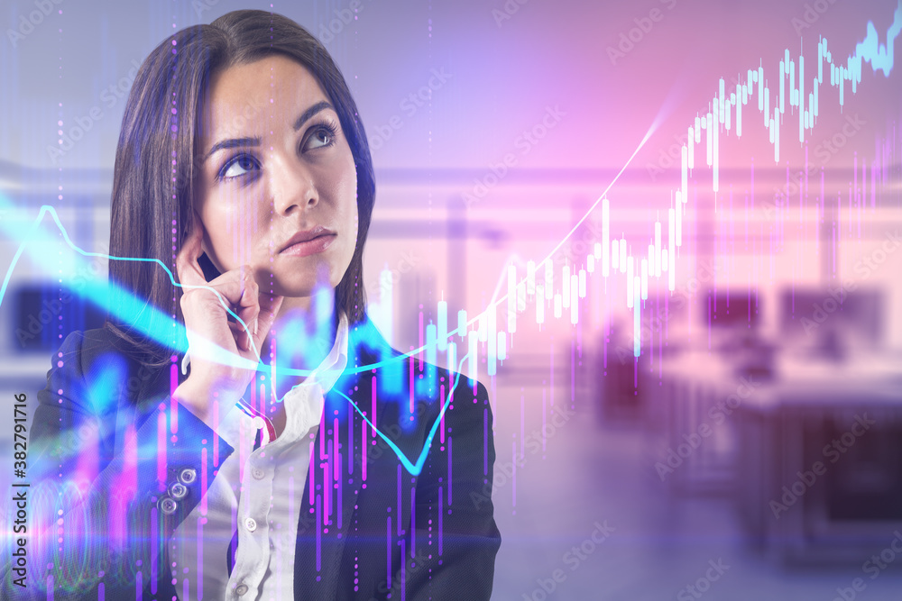 Attractive thoughtful young businesswoman standing in blurry office interior