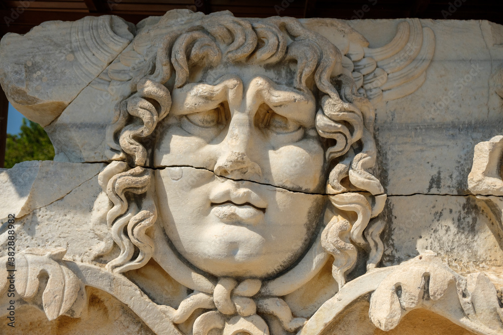 Head of man in the Temple of Apollo - Ancient Greek relief  - wall carving