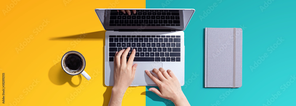 Person using a laptop computer from above