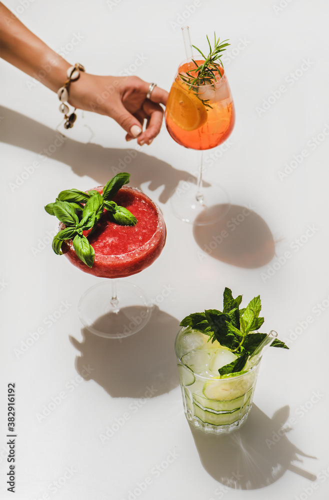 Popular bar summer ice alcoholic cocktails. Gin-tonic, Aperol Spritz and strawberry basil Margarita 