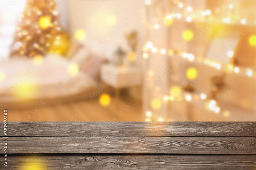 Closeup view of wooden table against blurred Christmas interior