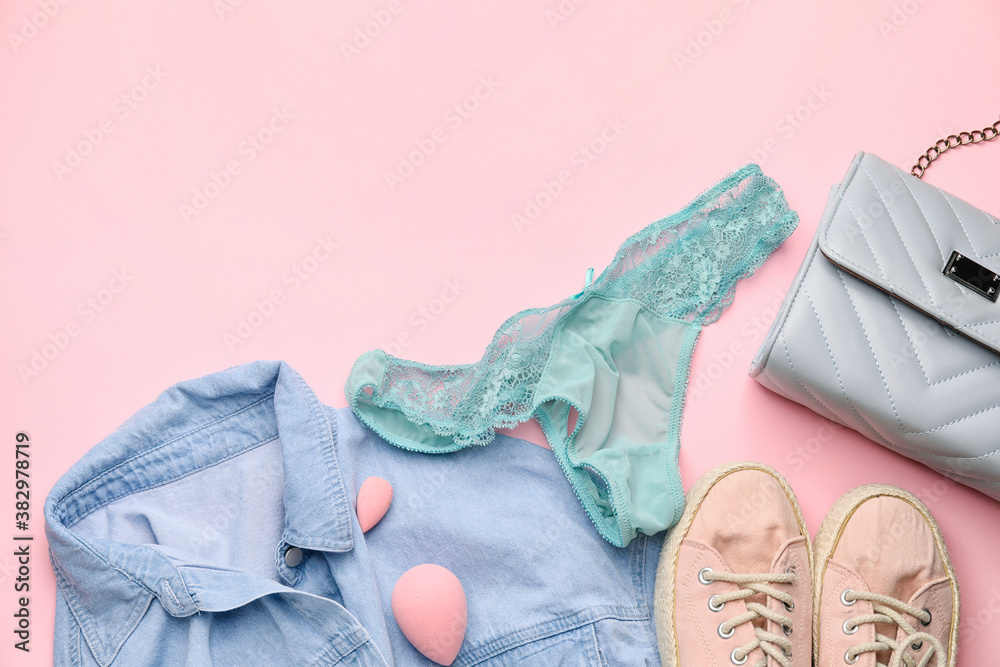 Stylish female clothes and accessories on color background