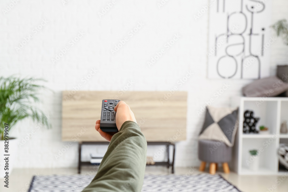 Young man watching TV at home