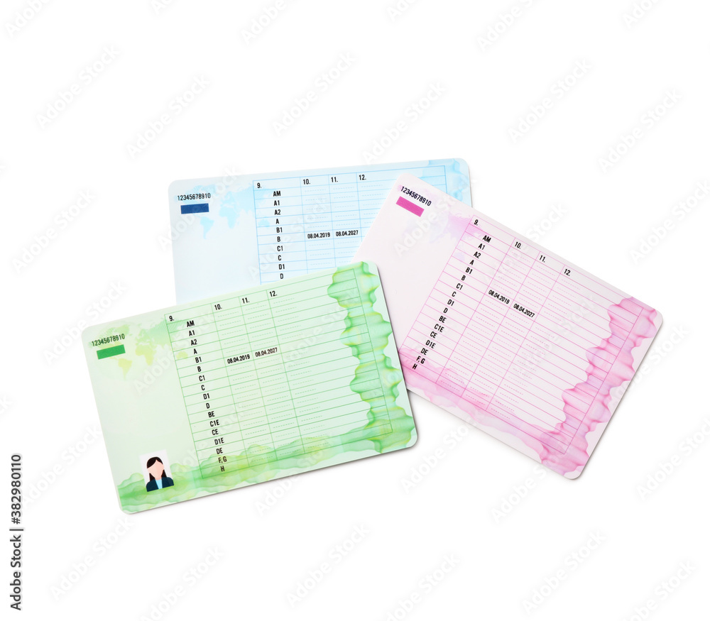 Different driving licenses on white background