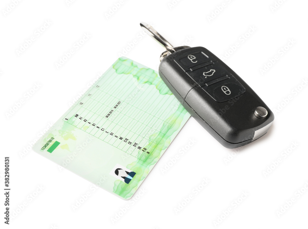 Driving license with car key on white background