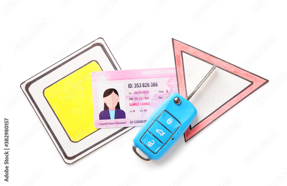 Driving license with car key and road signs on white background