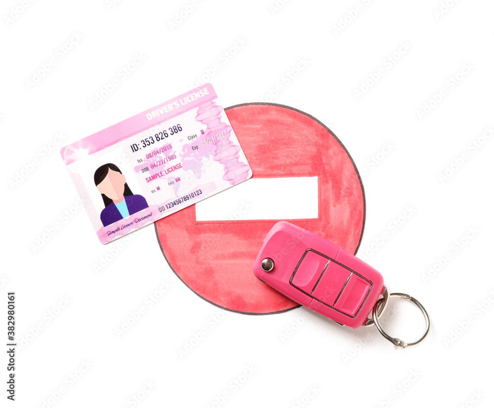 Driving license with car key and road sign on white background