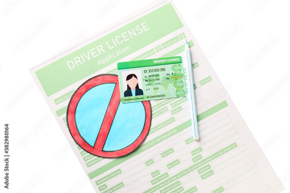 Driving license with application form, pen and road sign on white background