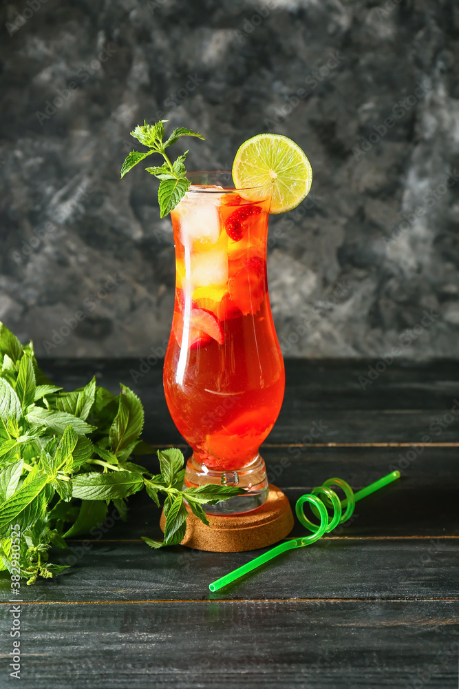 Glass of tasty strawberry cocktail mojito on table