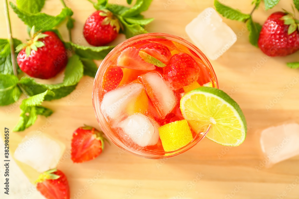 Glass of tasty strawberry cocktail mojito on table