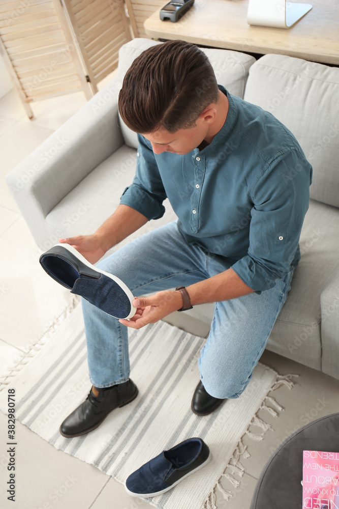 Man choosing new shoes in modern store