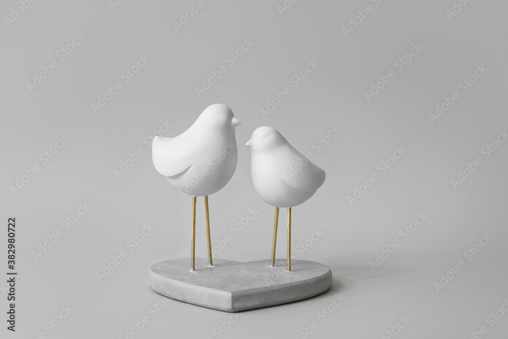 Decorative figure of birds on grey background