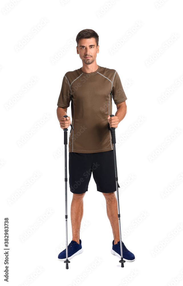 Young man with walking poles on white background