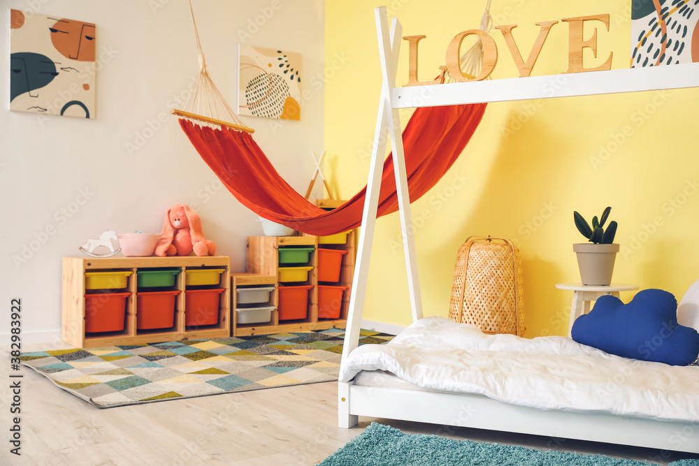 Interior of modern childrens room with comfortable bed