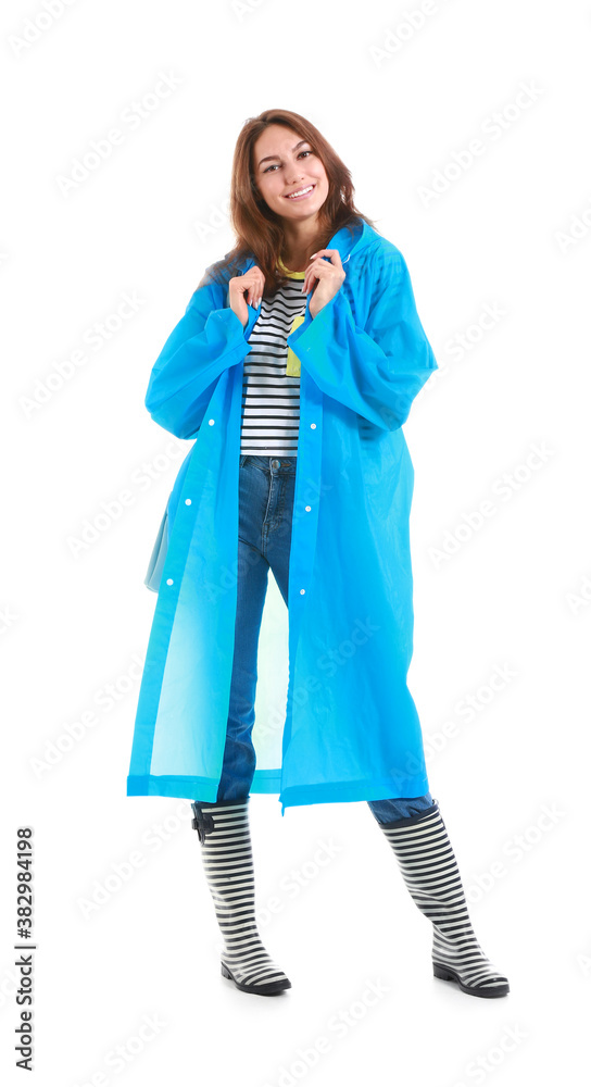 Beautiful young woman in raincoat on white background