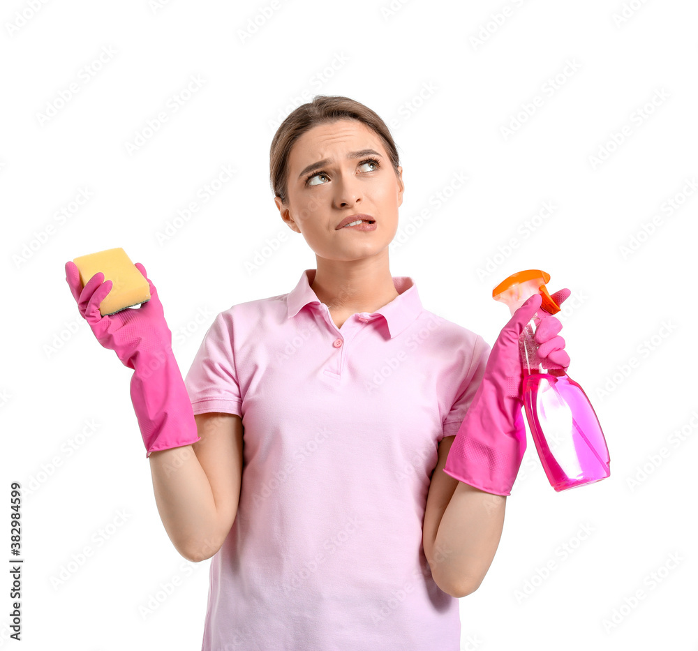 Young woman with cleaning supplies on white background