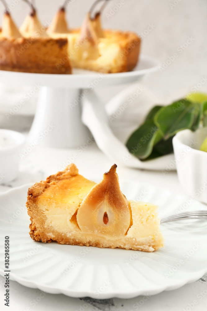 Plate with tasty pear cake on table