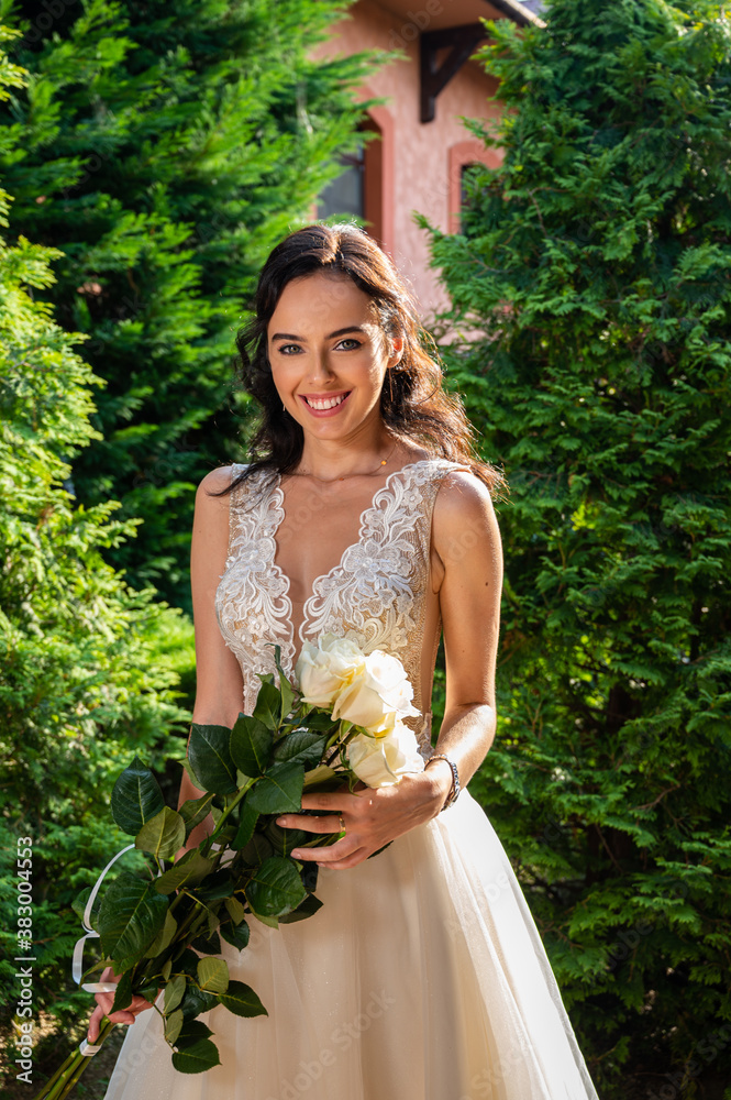 Modern bride in a beautiful dress in sunny day