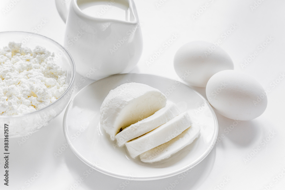 Healthy food concept with milk and cottage cheese on white table