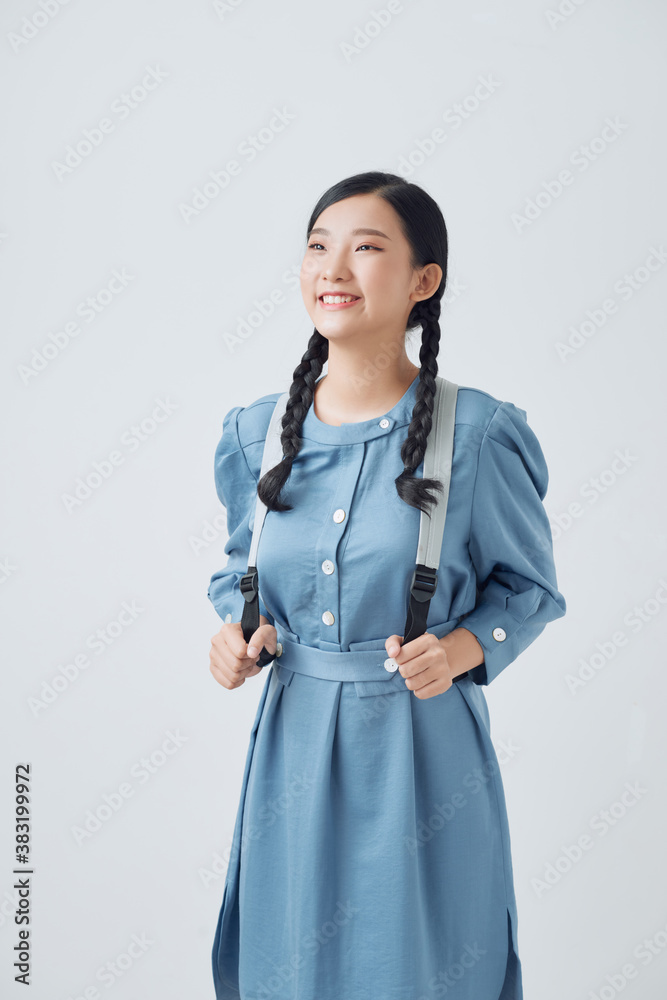 Attractive young female student with a gray backpack over her shoulder