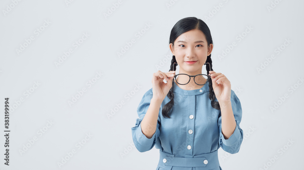 Beauty portrait of a young black healthy woman holding glasses and looking at camera