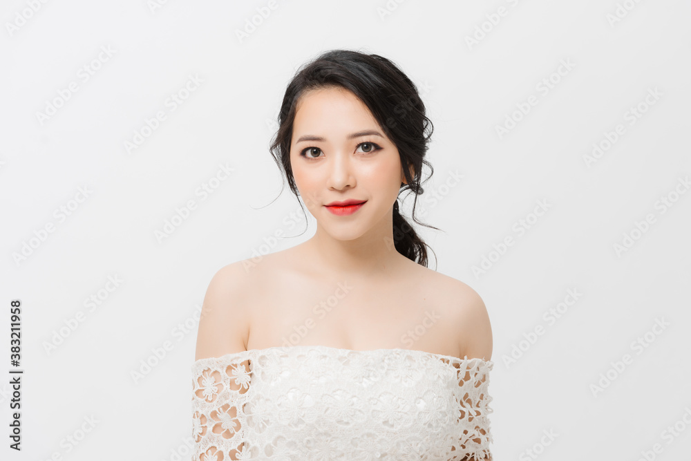 Portrait of elegant beautiful Asian woman in a white dress isolated on white background in studio.